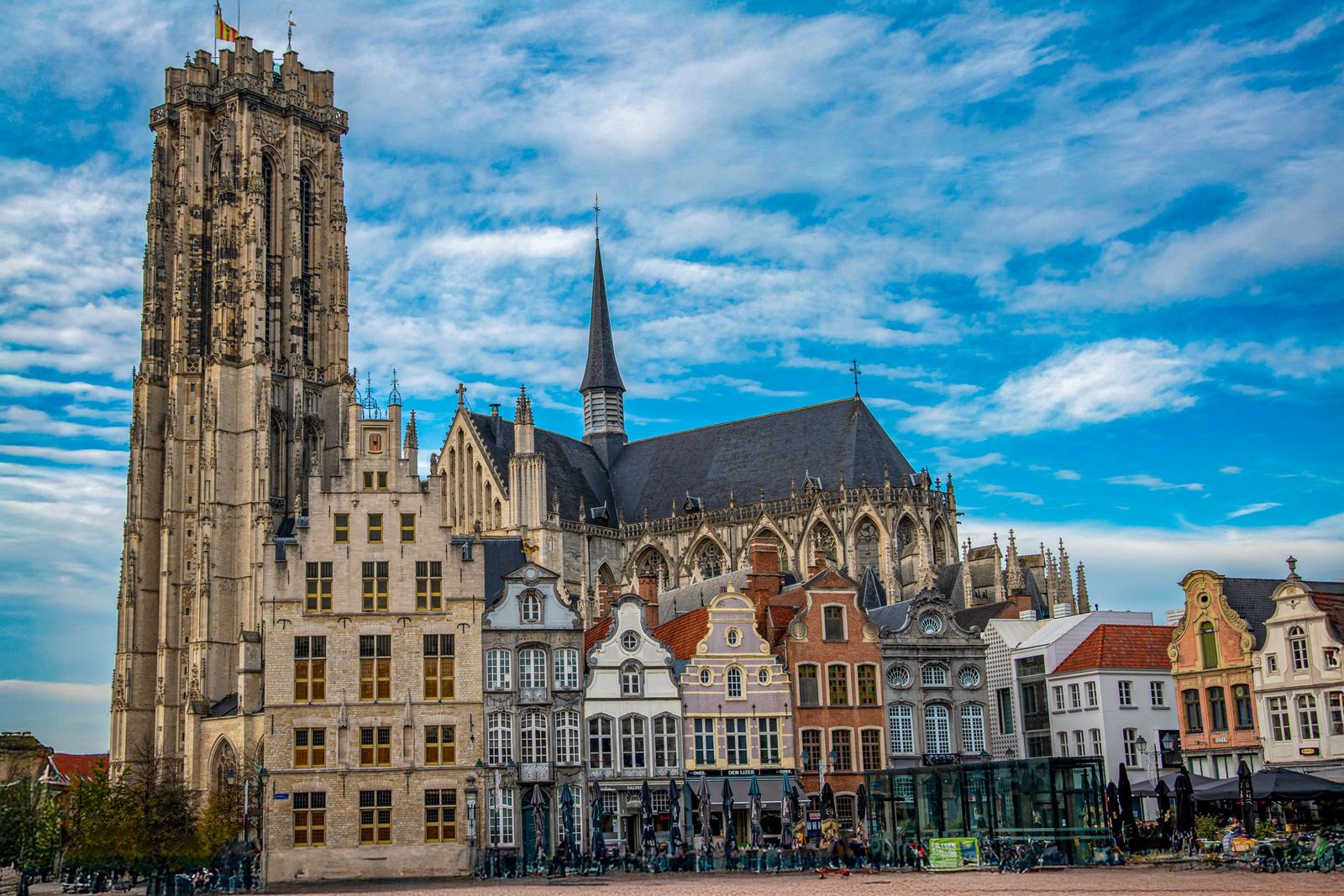 St Rumbold's Cathedral in Mechelen behind a row of colourful facades