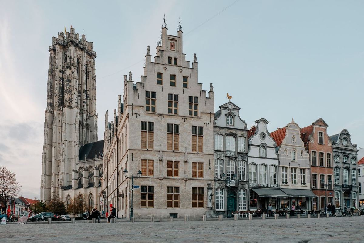 Historic facades and a church tower on the Grote Markt in Mechelen
