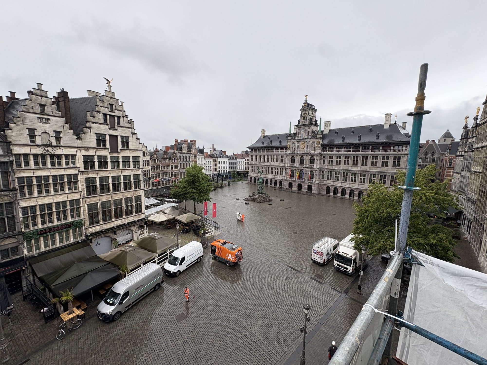 Antwerp's Grote Markt with Credim vans near a job site