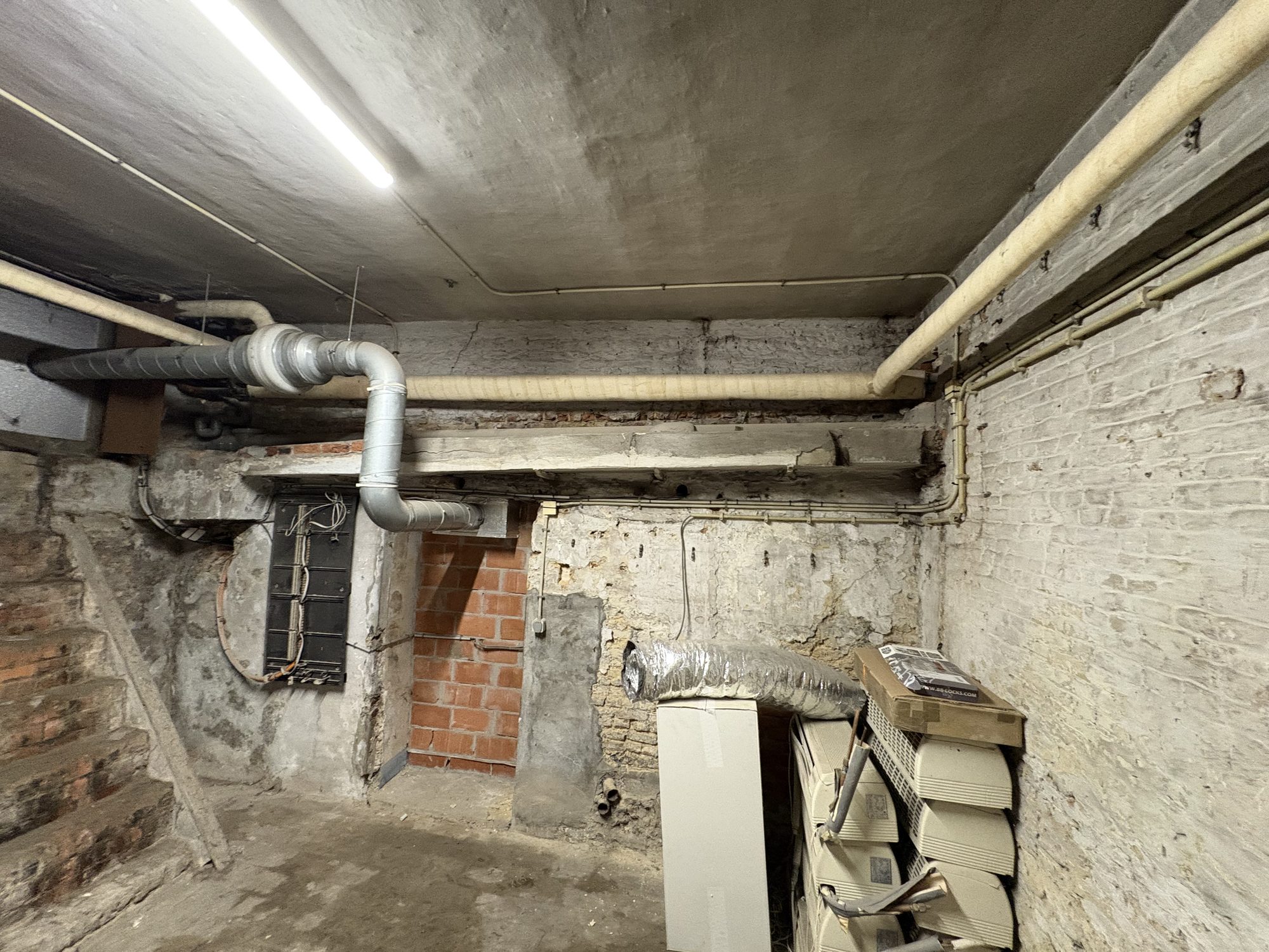 Basement with insulated pipes along the ceiling