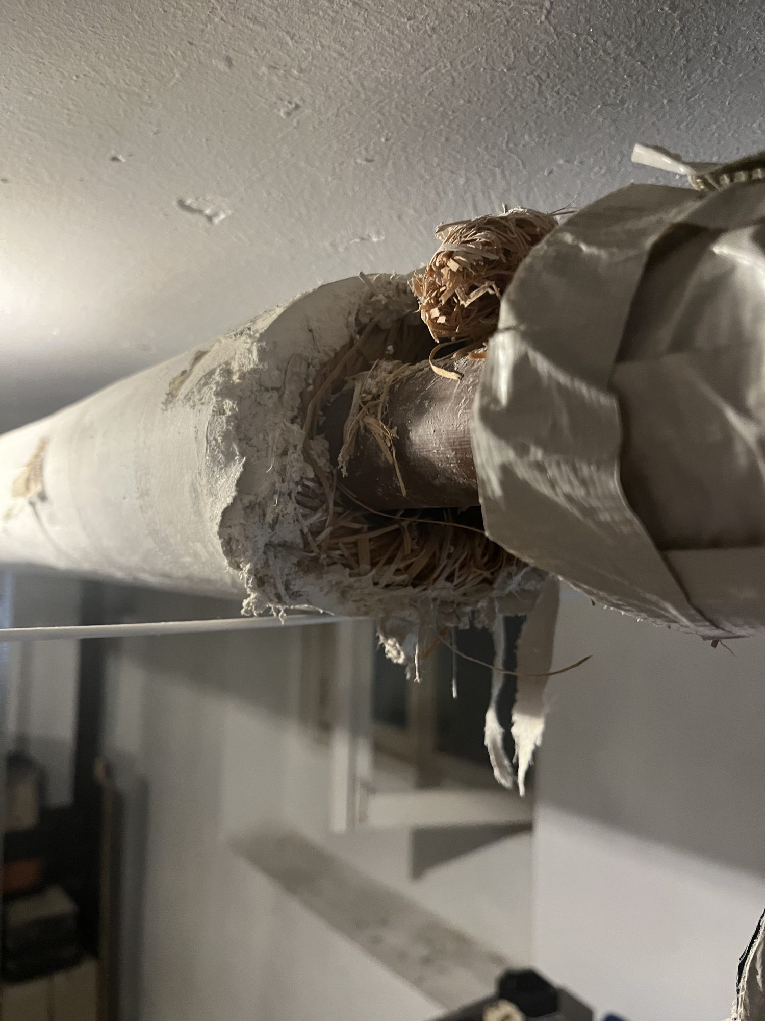 Close-up of damaged insulation around a pipe
